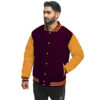 A guy wearing wool and bright gold sleeves maroon letterman jacket