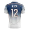 Back view of a navy blue and white polo shirt with a speckle fade, the name "NIXON," and the large number 12.
