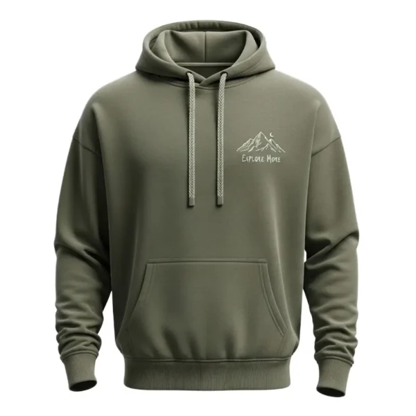 Front of an olive green oversized hoodie with a minimalist white line drawing of mountains and the text 'EXPLORE MORE' subtly printed on the chest.