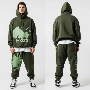 An olive green fleece tracksuit, featuring a light green paint splatter design across the hoodie and pants front, contrasted by the "OFF-GRID" text running down the back of the leg.
