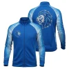Two-panel image showing the front and back of a royal blue cheer warm-up jacket with white printed sleeves and a large, eye-catching blue and silver rhinestone lion logo on the back.
