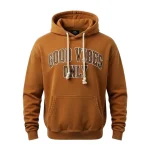 Front of a burnt orange or rust-colored pullover hoodie with a subtle stone-wash finish, featuring the text 'GOOD VIBES ONLY' in a white and dark outline varsity font.