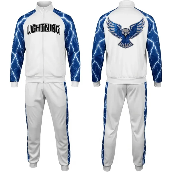 Full white and blue tracksuit, complete with lightning print sleeves, matching pants, and a dazzling blue rhinestone bird logo centered on the back of the jacket.