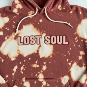 Closeup of custom bleach washed hoodie with puff print text "LOST SOUL"