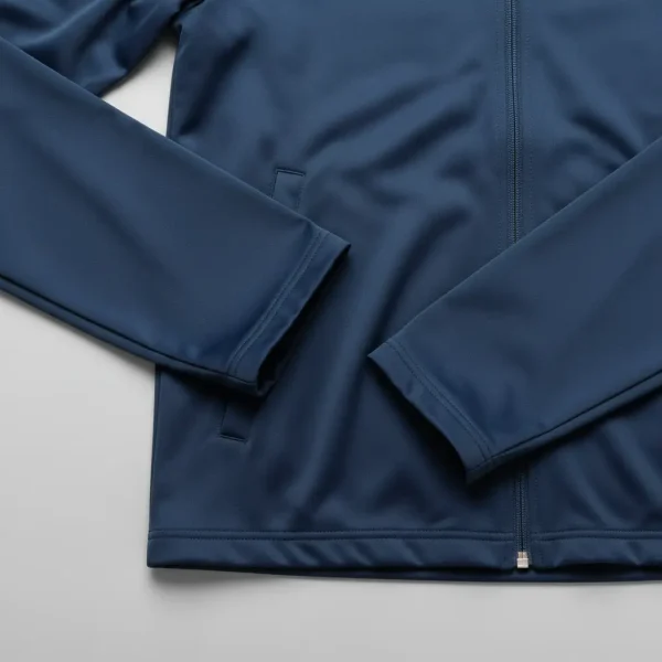 Closeup of navy-blue plain hems track jacket.