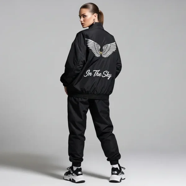 Back view of a black nylon jacket with white wing graphics and "In The Sky" script.