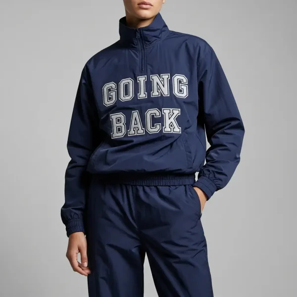Navy blue nylon tracksuit with "GOING BACK" block letter applique embroidery on the chest.