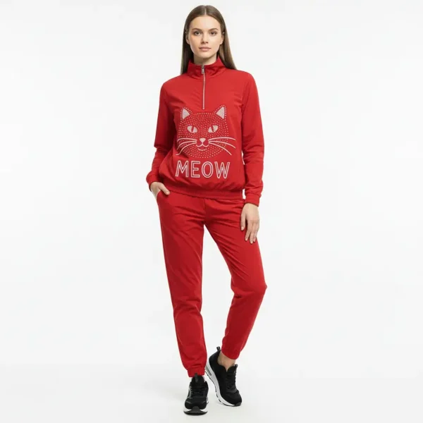 Woman wearing a red nylon tracksuit featuring a rhinestone cat graphic and "MEOW" text.