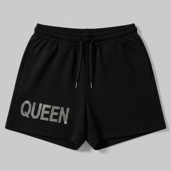 Black fleece sweat shorts featuring a decorative rhinestone graphic on the left leg.