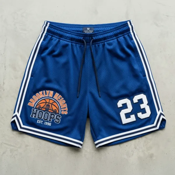Pair of bright blue mesh basketball shorts featuring high-quality white embroidery on the lower leg.
