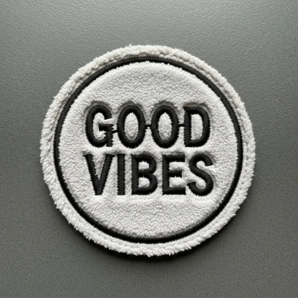 A chenille patch with embroidered text "GOOD VIBES".
