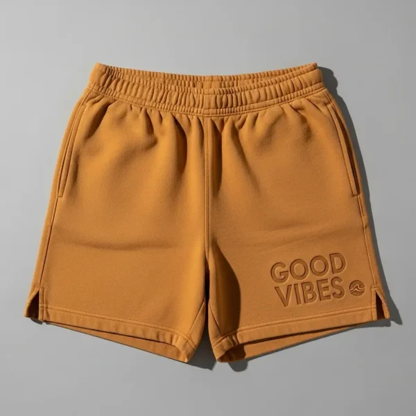 Mustard yellow sweat shorts featuring a subtle debossed logo texture.