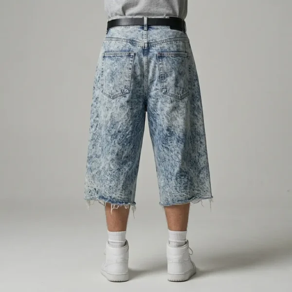 Back view of oversized denim jorts featuring a heavy acid wash finish and a relaxed, baggy fit.