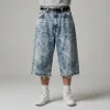 Front view of oversized denim jorts featuring a heavy acid wash finish and a relaxed, baggy fit.