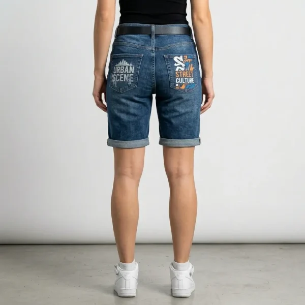 Back view of long Bermuda-style denim shorts featuring custom graphic prints on both pockets.