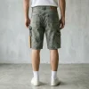 Back view of utility-style carpenter denim shorts showing tool pockets, hammer loops, and reinforced stitching.