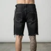 Back view of heavyweight denim jorts embellished with metallic studs and decorative side chains for a punk-inspired look.