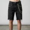 Front view of heavyweight denim jorts embellished with metallic studs and decorative side chains for a punk-inspired look.