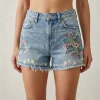 Custom denim shorts featuring colorful intricate floral embroidery on the front.