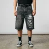 Baggy skater-style denim jorts featuring large side cargo pocket and a fire skull logo on the front.