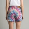 Back view of light wash denim shorts featuring a custom blue and white tie-dye bleach effect.