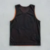 Black and orange reversible basketball pinnie, black back.