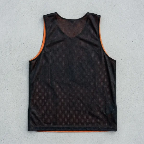 Black and orange reversible basketball pinnie, black back.