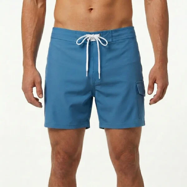 Blank blue mid-thigh length board shorts.