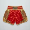 Back view of red satin Legend Fightwear Muay Thai shorts with gold trim and traditional embroidered twin dragon designs on the sides.