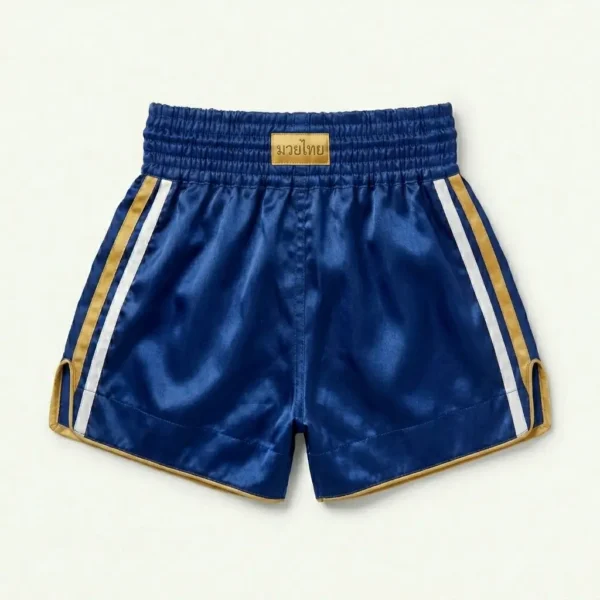 Back view of royal blue satin Muay Thai shorts featuring an embroidered tiger graphic and a gold traditional pattern on the left side.