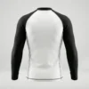 Back view of a white athletic compression rash guard featuring clean panels and contrasting solid black short sleeves.