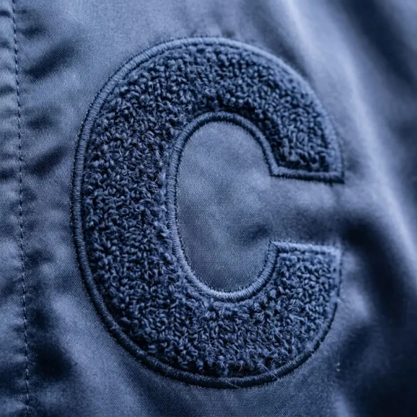 Chenille embroidered letter on satin jacket.