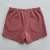 Front view of custom pink embroidered booty shorts.