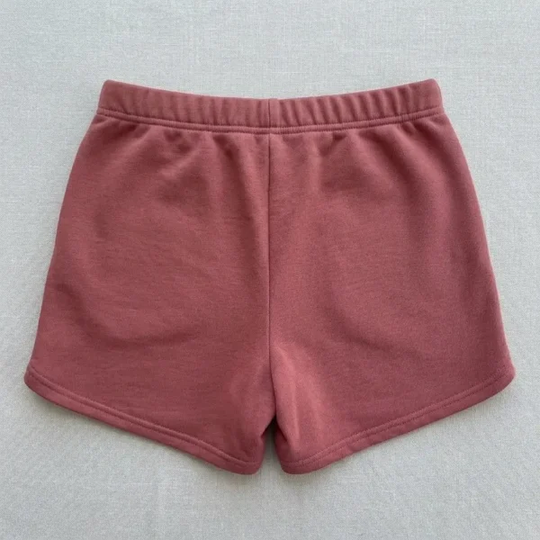 Front view of custom pink embroidered booty shorts.