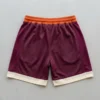 Custom orange, maroon, and cream color block basketball shorts back.