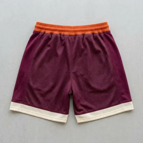 Custom orange, maroon, and cream color block basketball shorts back.
