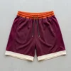 Custom orange, maroon, and cream color block basketball shorts front.