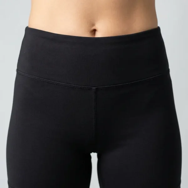 Closeup front view of high-rise black booty shorts.