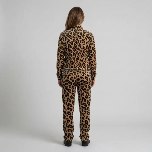 Back view of a woman wearing beige black leopard print velour tracksuit.