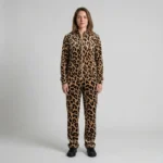 Front view of a woman wearing beige black leopard print velour tracksuit.