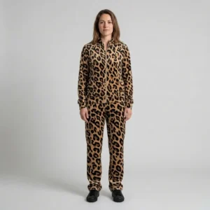 Front view of a woman wearing beige black leopard print velour tracksuit.