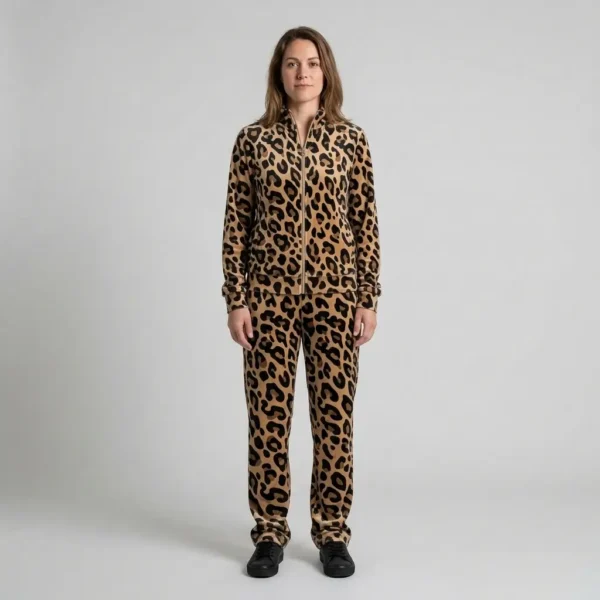 Front view of a woman wearing beige black leopard print velour tracksuit.
