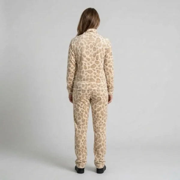 Back view of a woman wearing beige textured spotted animal print velour tracksuit.