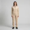 Front view of a woman wearing beige textured spotted animal print velour tracksuit.