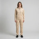 Front view of a woman wearing beige textured spotted animal print velour tracksuit.