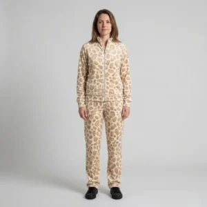 Front view of a woman wearing beige textured spotted animal print velour tracksuit.