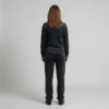 Back view of a woman wearing black charcoal spotted animal print velour tracksuit.