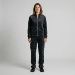 Front view of a woman wearing black charcoal spotted animal print velour tracksuit.