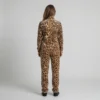 Back view of a woman wearing caramel cream leopard print velour tracksuit.