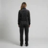 Back view of a woman wearing charcoal abstract leopard print velour tracksuit.